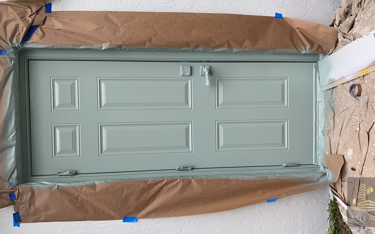 Before — sage green door, masked and ready for paint